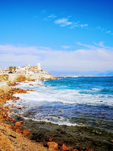 Waves crash against the stone ramparts that surround Antibes Old Town