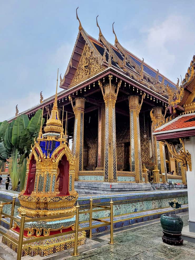 Wat Phra Kaew (The Temple of the Emerald Buddha) in Bangkok's Grand Palace complex. The Temple is highly decorated with mirror tiles and coloured glass mosaic adorning the roof, walls and columns. 