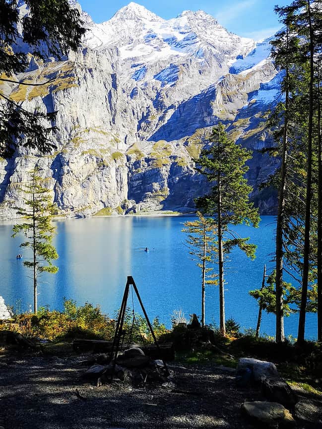 One of the barbecue pits at Oeschinensee and a rowing boat in the background, Kandersteg, Switzerland 