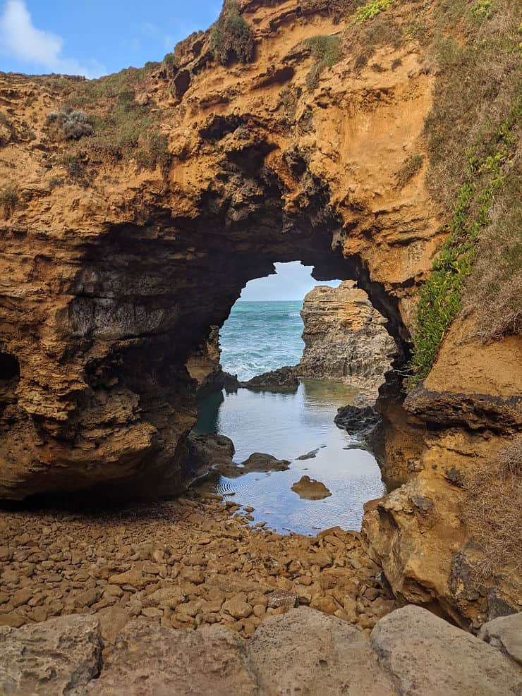The Grotto on the Great Ocean Road is a rocky cove, with arches formed from the golden rocks which stand over shallow pools, looking out to the ocean