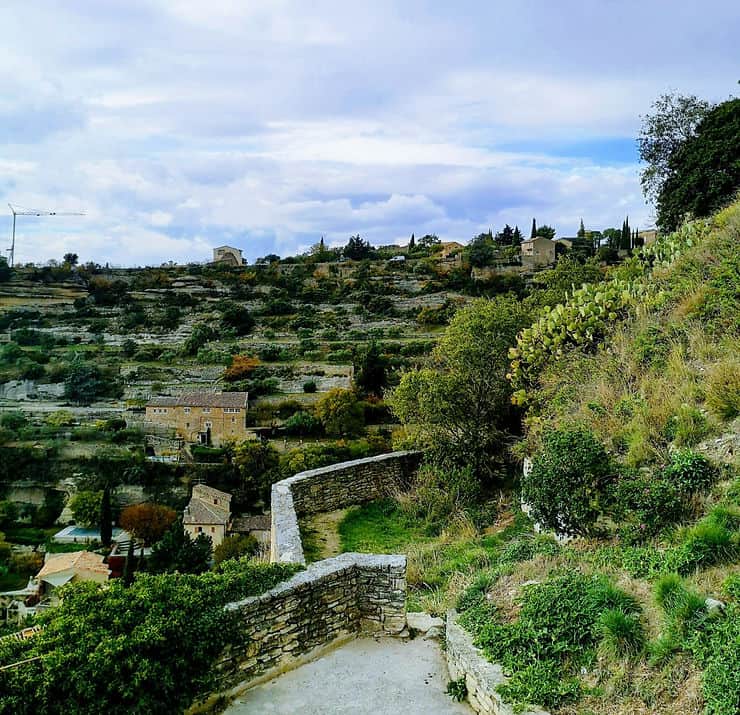 Stone houses perch along the hillside sprawling out from the centre of Gordes Village