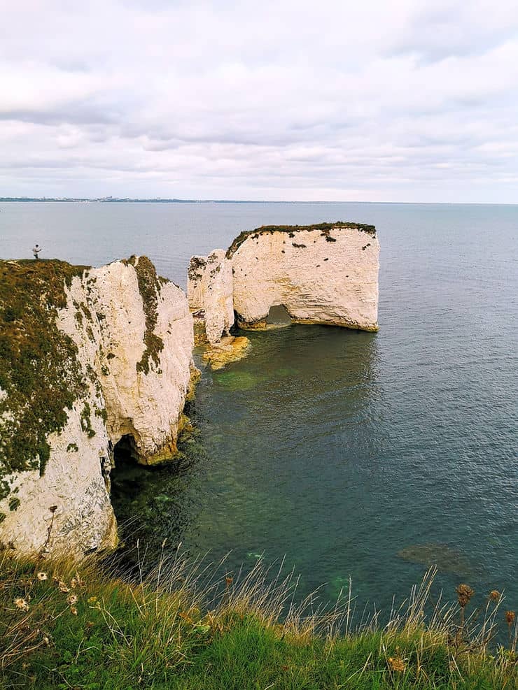 The white cliffs of Old Harry rocks juts out into the sea in Studland, Dorset