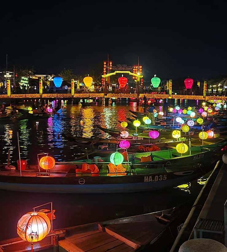 Rowing boats on the Hoi An river at night, illuminated with colourful lanterns