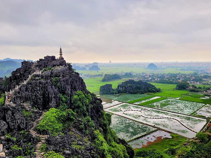 A small temple sits atop Hang Mua Viewpoint, with views over the rice fields and countryside in Tam Coc, Vietnam