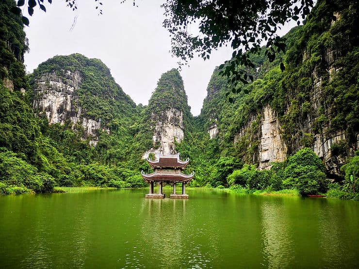 A small temple sits in the water in Trang An Scenic Landscape