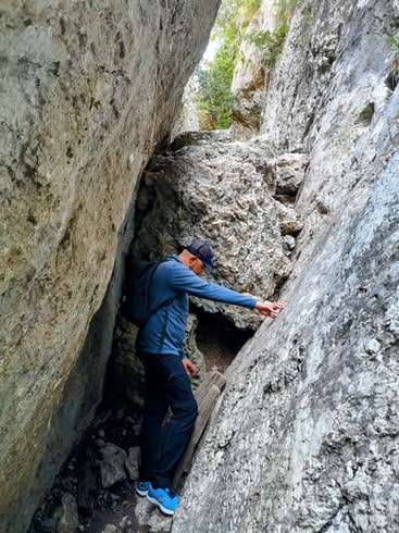 Preparing to climb over a large boulder in the Gorges du Regalon in Provence