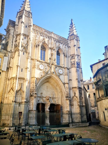 An ornate church is hidden in a small square reached through a narrow alleyway