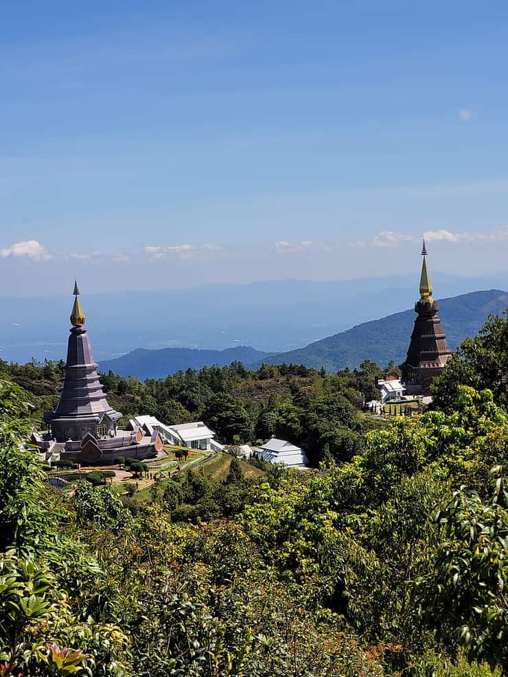 The Twin King and Queen Pagoda stand high above the thick tree line in Doi Inthanon National Park 