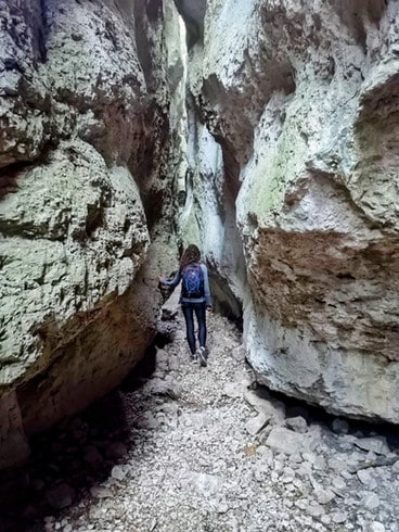 Walking through a narrow passage in Gorges du Regalon in Provence 
