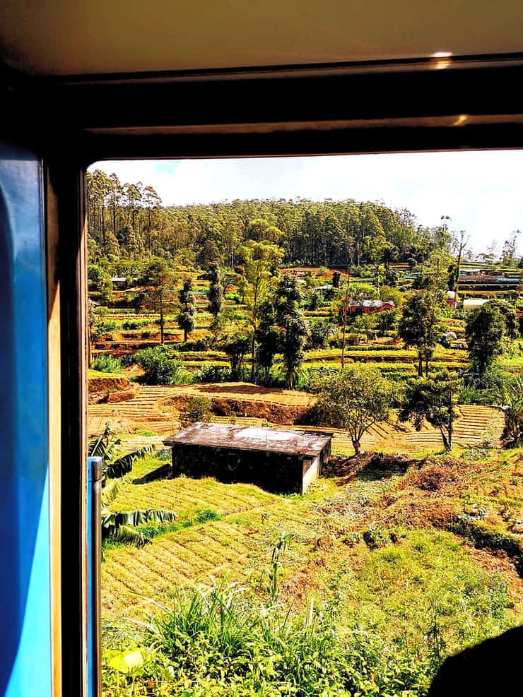 Views from the open door on the Kandy - Ella train across villages tea plantations, Sri Lanka 