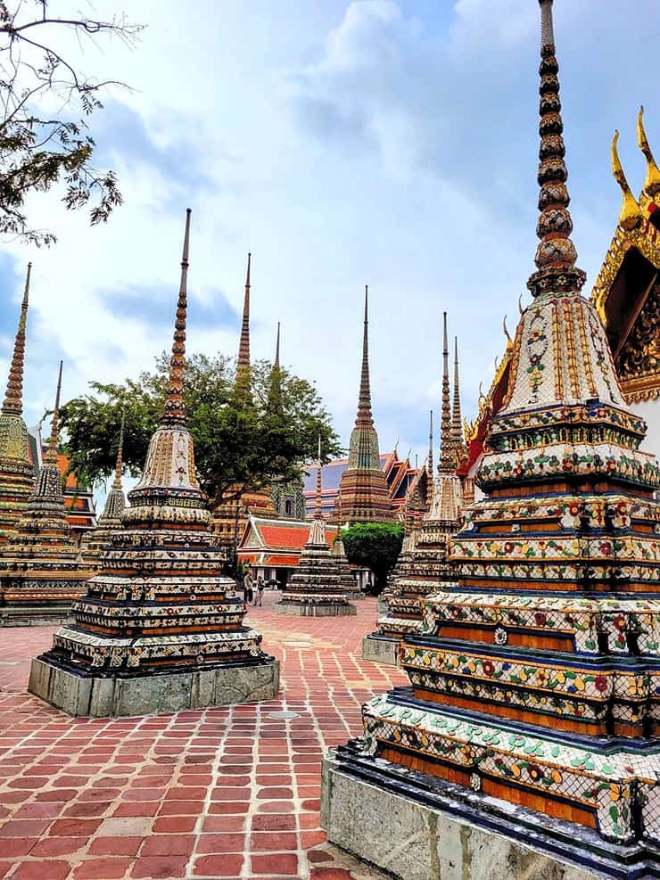 Decorated pagodas stand in between temple buildings in Wat Pho, Bangkok