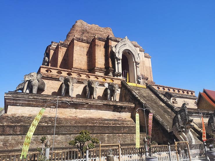 The ruins of the brick-built Wat Chedi Luang, with elephant statues facing outwards around the outside of the temple