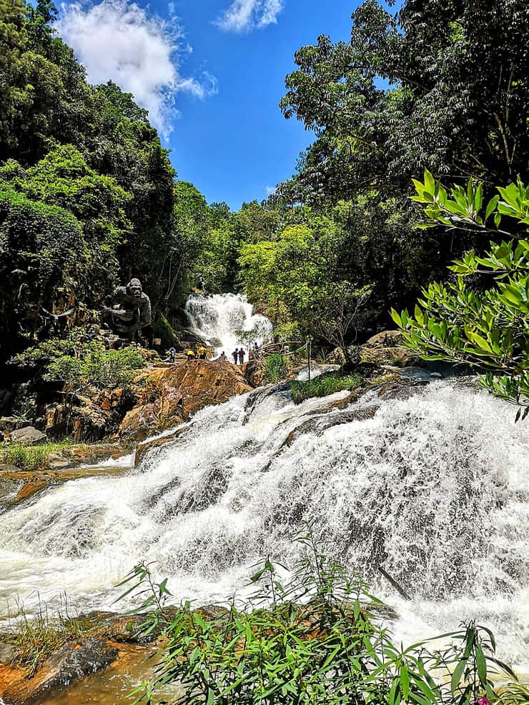 A wide waterfall surrounded by thick green forest in Dalat, Vietnam