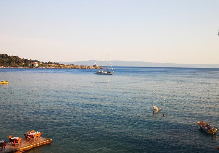 Views from Makarska promenade across the sea and to St Peter's Forest park in Croatia