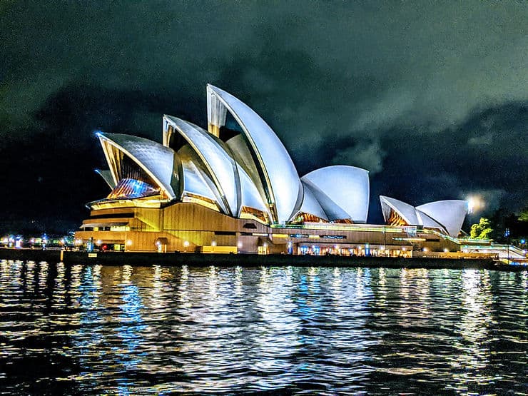 The Sydney Opera House at night, viewed from a boat on the water