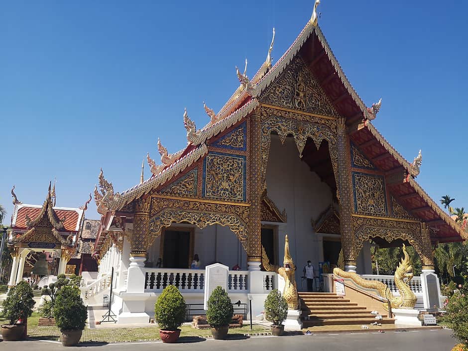 Wat Phra Singh temple in Chiang Mai, with its pointed gold roof and blue and gold decorated tiles.