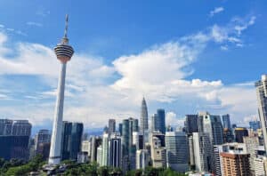 Tall skyscrapers rise towards the light blue sky of Kuala Lumpur