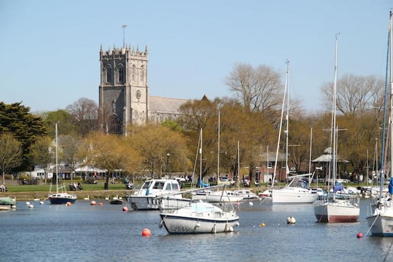 The small marina and church in Christchurch, Dorset