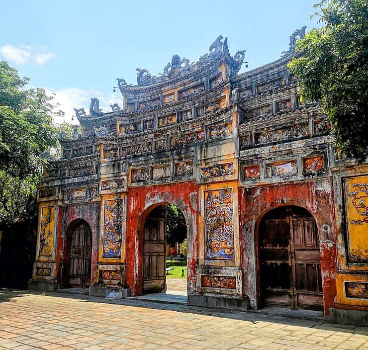 A colourful entrance gate with detailed carvings in Hue ancient city, Vietnam