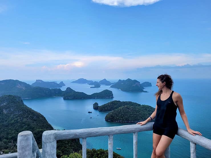 Woman standing at a viewpoint looking out at the islands of Ang Thong Marine Park in Thailand