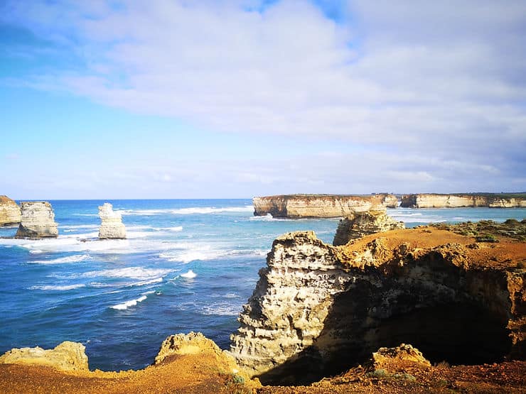 The Bay of Islands, along Australia's Great Ocean Road is a series of golden orange rock formations, jutting out of the deep blue ocean