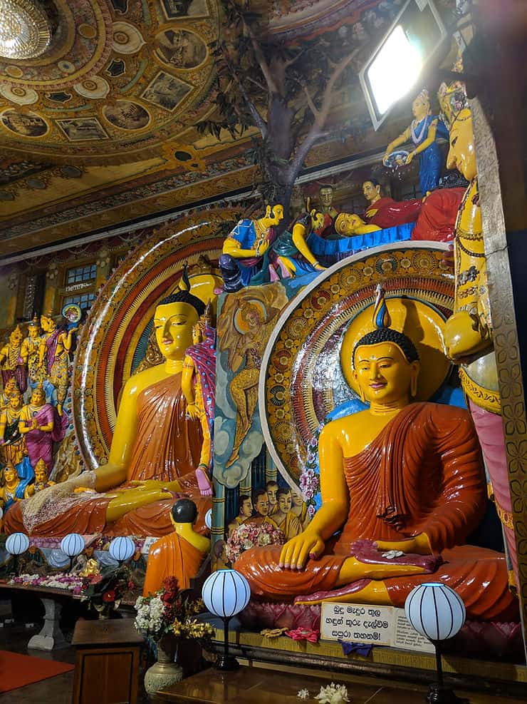 Colourful Buddhist statues inside the Gangamara temple, Colombo, Sri Lanka 