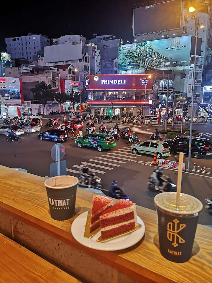 Watching the traffic of Ho Chi Minh City with coffee and cake, Vietnam