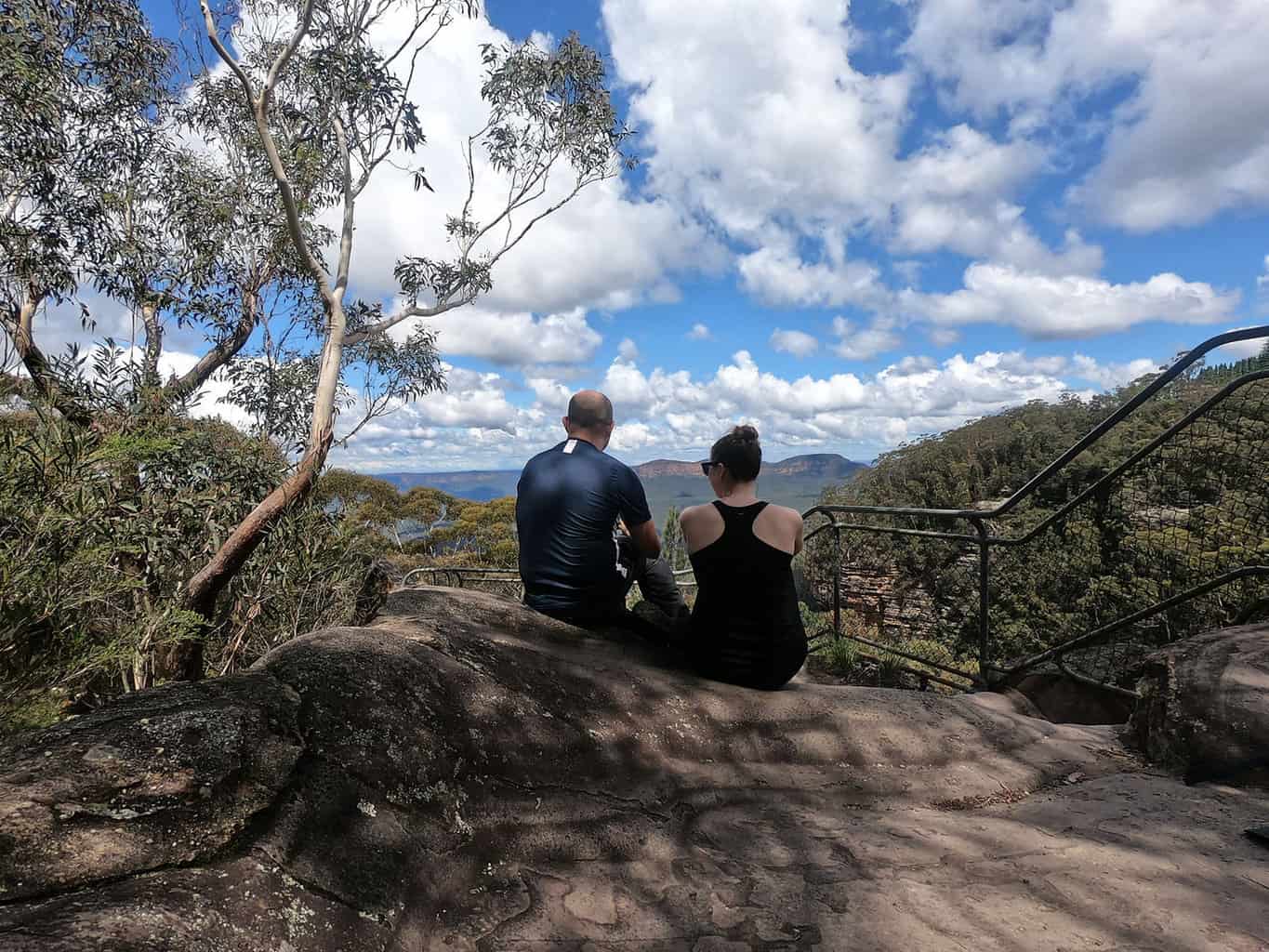 Admiring the view of thick green forest over the Blue Mountains National Park from a shady spot along the Prince Henry cliff walk
