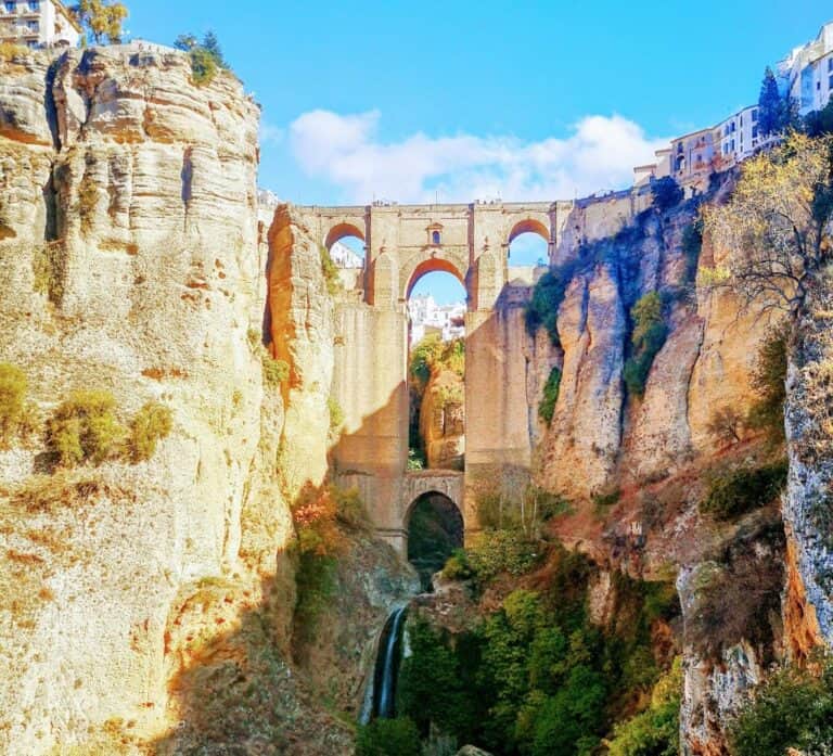 A stone bridge spans a 120m gorge with arched detail in the Spanish town of Ronda