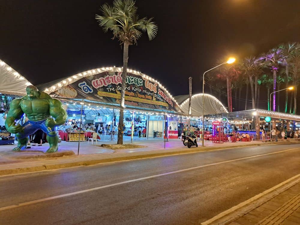 A large statue of the Hulk stands outside the front of a large covered market in Phuket, Thailand